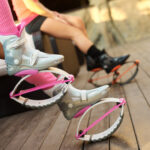 pink kangoo jumps boots at womans legs.
